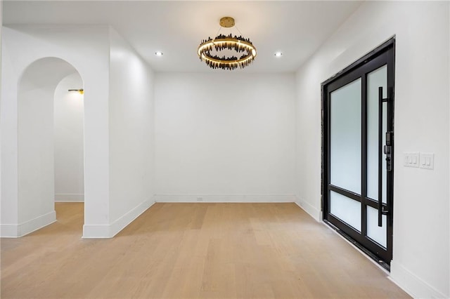 15154 Hopewell Rd, Alpharetta, GA 30004 - empty room with light wood finished floors, recessed lighting, arched walkways, and baseboards