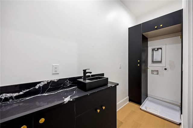 15154 Hopewell Rd, Alpharetta, GA 30004 - bathroom with a sink, wood finished floors, and baseboards