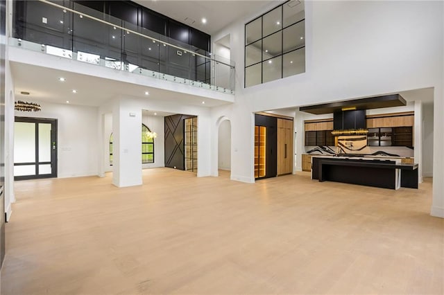 15154 Hopewell Rd, Alpharetta, GA 30004 - unfurnished living room featuring a high ceiling, light wood-style flooring, baseboards, and recessed lighting