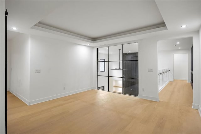 15154 Hopewell Rd, Alpharetta, GA 30004 - empty room featuring a tray ceiling, light wood-type flooring, baseboards, and recessed lighting