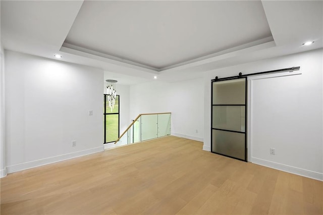 15154 Hopewell Rd, Alpharetta, GA 30004 - empty room featuring a tray ceiling, recessed lighting, light wood-type flooring, baseboards, and a chandelier