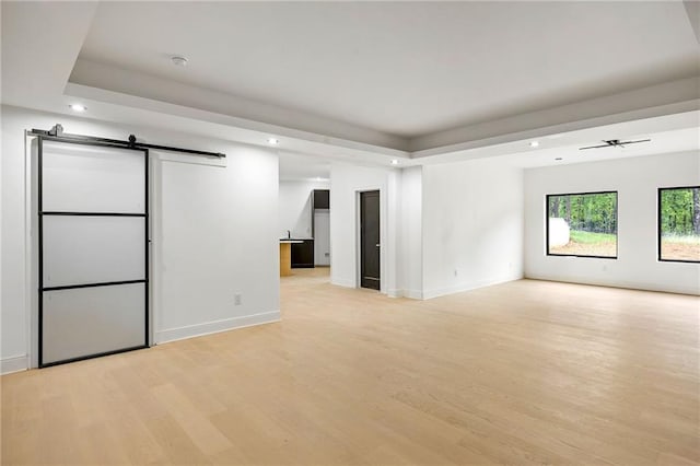 15154 Hopewell Rd, Alpharetta, GA 30004 - unfurnished room featuring light wood-style flooring, recessed lighting, baseboards, a barn door, and a ceiling fan