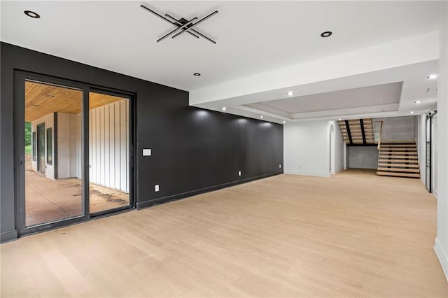 15154 Hopewell Rd, Alpharetta, GA 30004 - unfurnished living room with light wood-style floors, stairs, baseboards, a tray ceiling, and recessed lighting
