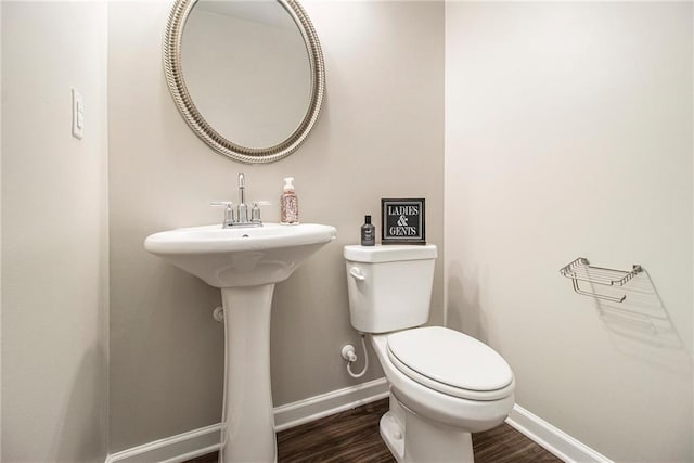 bathroom with wood-type flooring and toilet