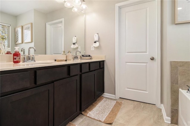 bathroom featuring a tub to relax in and vanity