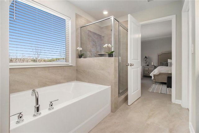 bathroom with independent shower and bath and tile patterned flooring