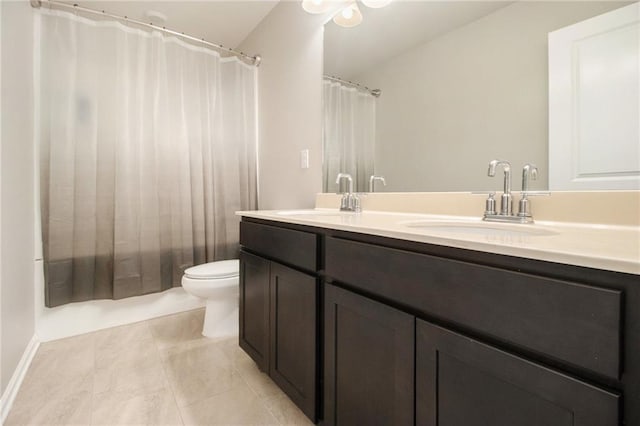 bathroom featuring vanity, tile patterned floors, and toilet