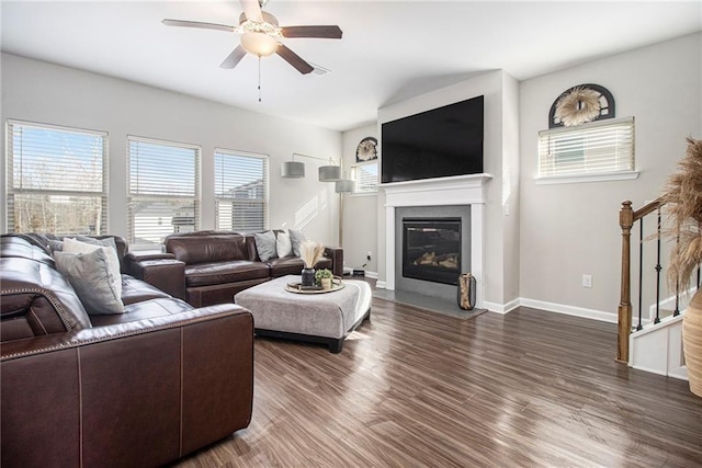 living room with dark hardwood / wood-style flooring and ceiling fan