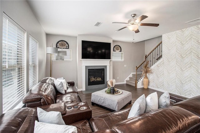 living room featuring ceiling fan and dark hardwood / wood-style flooring