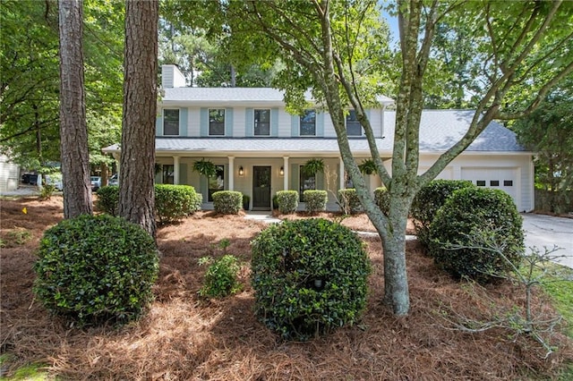 9165 Eves Cir, Roswell, GA 30076 - view of front facade featuring a garage, driveway, a chimney, a porch, and roof with shingles