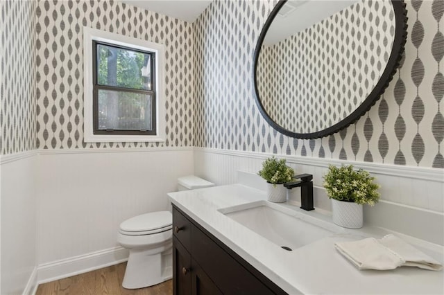 9165 Eves Cir, Roswell, GA 30076 - half bath with wallpapered walls, wainscoting, vanity, and wood finished floors