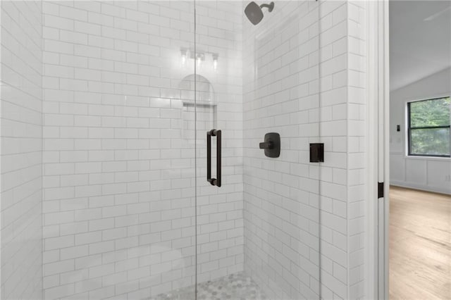 9165 Eves Cir, Roswell, GA 30076 - bathroom with a stall shower, wood finished floors, and vaulted ceiling