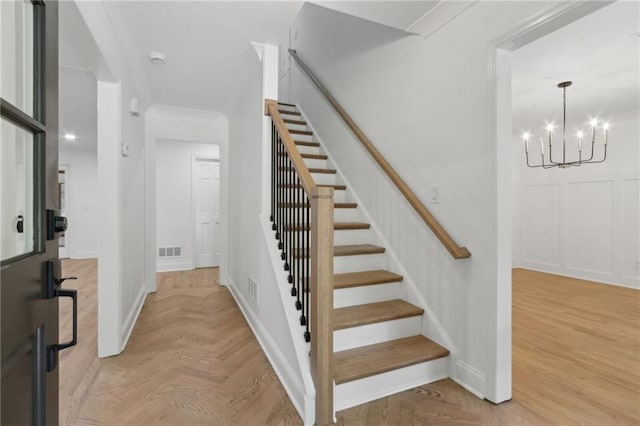 9165 Eves Cir, Roswell, GA 30076 - stairway featuring a chandelier and ornamental molding