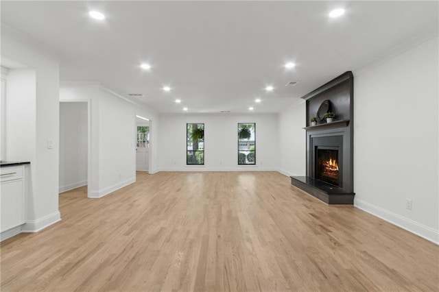 9165 Eves Cir, Roswell, GA 30076 - unfurnished living room featuring a fireplace, recessed lighting, light wood-style flooring, and crown molding