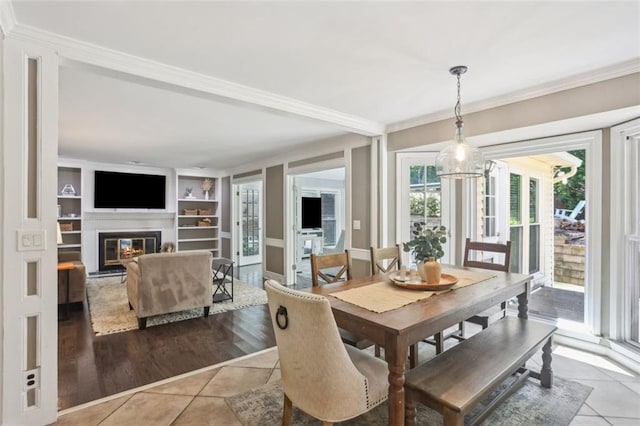 3837 Fenway Xing, Marietta, GA 30062 - dining room with tile patterned flooring, ornamental molding, built in features, and a glass covered fireplace