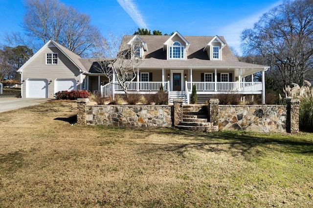 view of front of property with a garage, covered porch, stairs, and a front yard