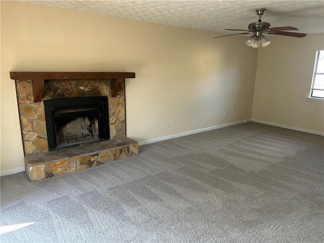 unfurnished living room with ceiling fan, carpet, a textured ceiling, and a fireplace