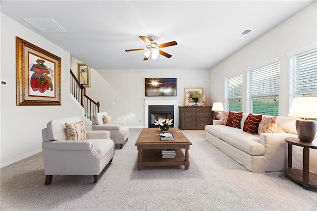 carpeted living room featuring ceiling fan