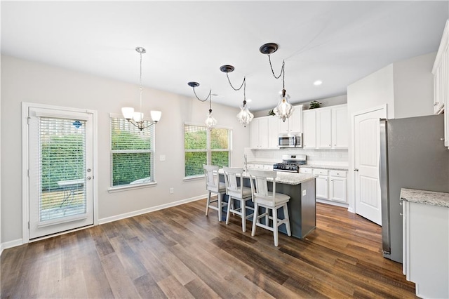 kitchen with white cabinets, plenty of natural light, and stainless steel appliances