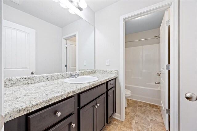 full bathroom featuring bathing tub / shower combination, vanity, and toilet