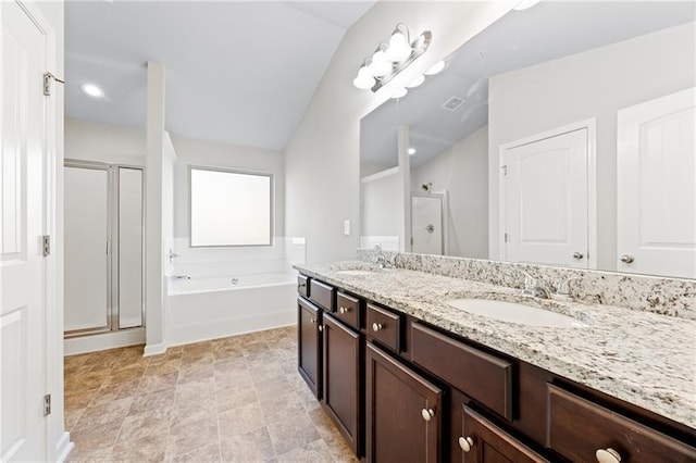 bathroom with vanity, vaulted ceiling, and shower with separate bathtub