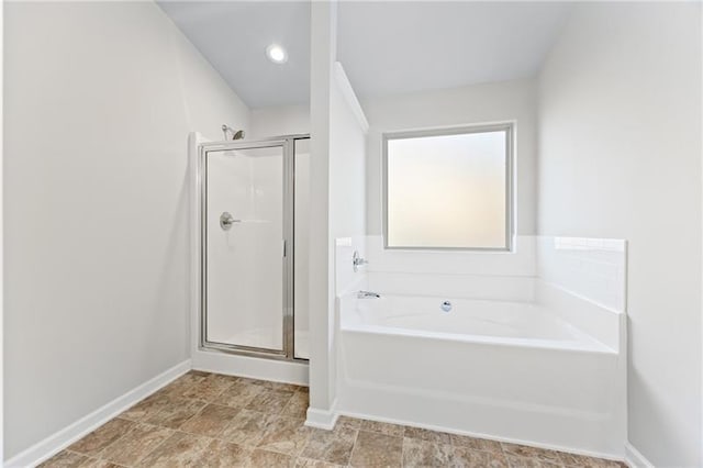 bathroom with shower with separate bathtub