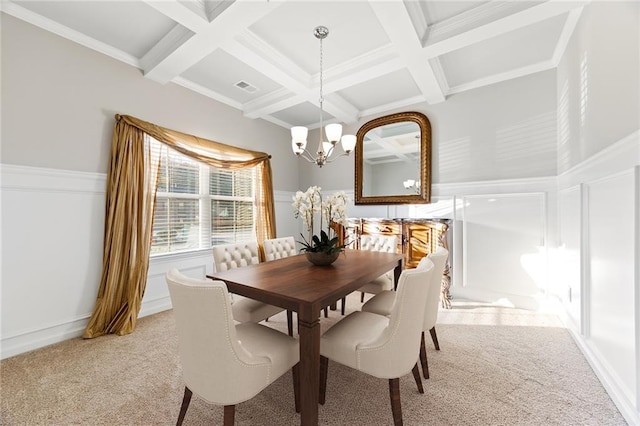 dining space featuring coffered ceiling, an inviting chandelier, beamed ceiling, light colored carpet, and ornamental molding