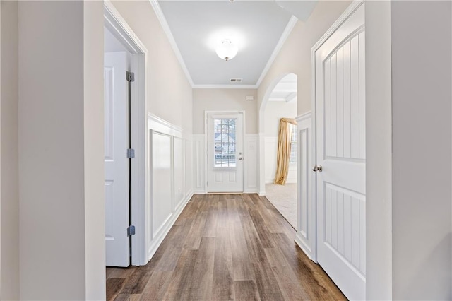 doorway featuring hardwood / wood-style floors and ornamental molding