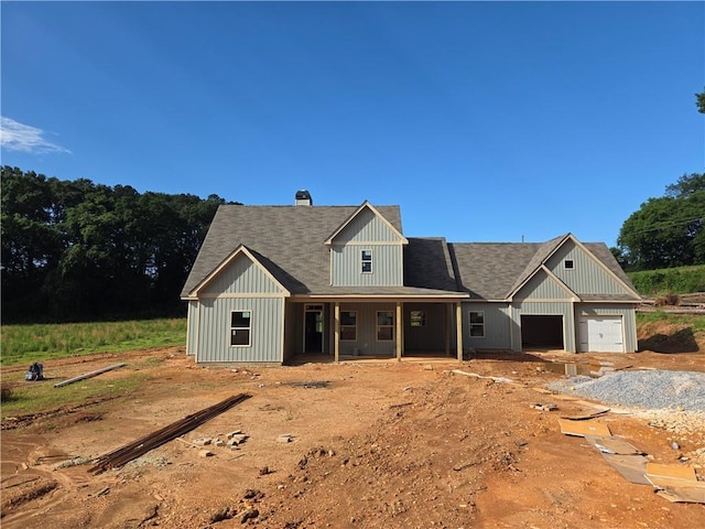 34 Hawkins Rd, Taylorsville, GA 30178 - view of front of home featuring an attached garage, a porch, driveway, a chimney, and board and batten siding