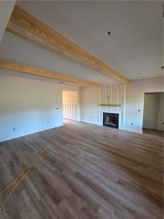 34 Hawkins Rd, Taylorsville, GA 30178 - unfurnished living room with beam ceiling, wood finished floors, baseboards, and a fireplace