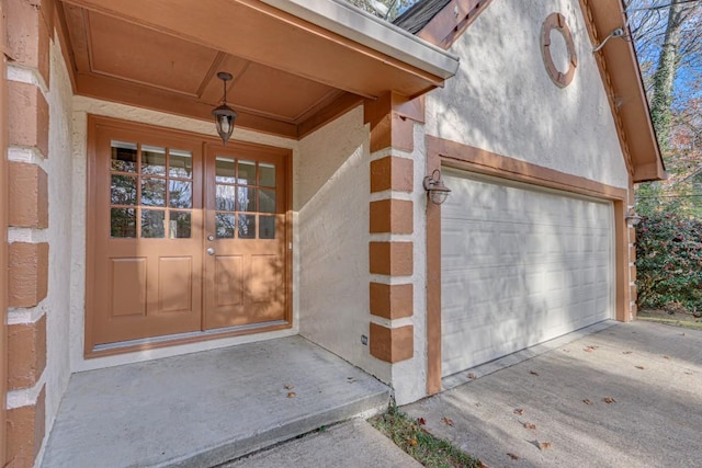 entrance to property with french doors and a garage