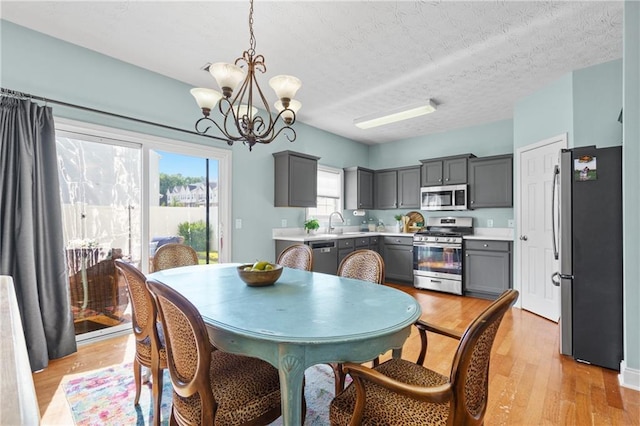 80 Riley Place Dr, Dawsonville, GA 30534 - dining room featuring a chandelier, light wood-type flooring, and a textured ceiling
