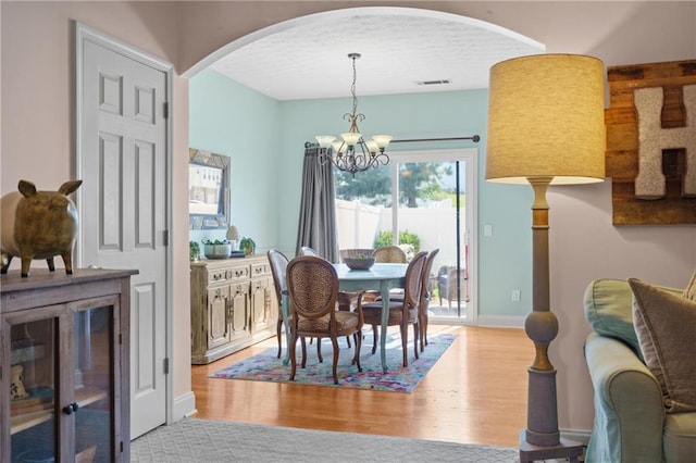 80 Riley Place Dr, Dawsonville, GA 30534 - dining room with a chandelier, arched walkways, and wood finished floors