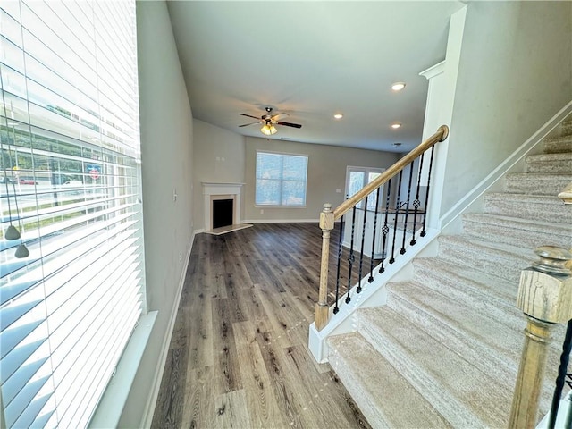 unfurnished living room featuring hardwood / wood-style flooring and ceiling fan