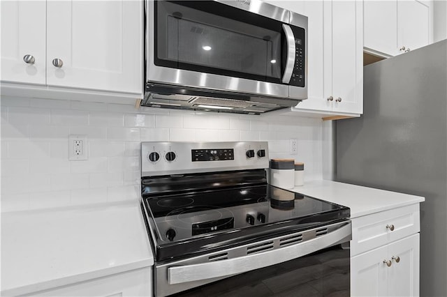 kitchen with stainless steel appliances, light countertops, decorative backsplash, and white cabinetry