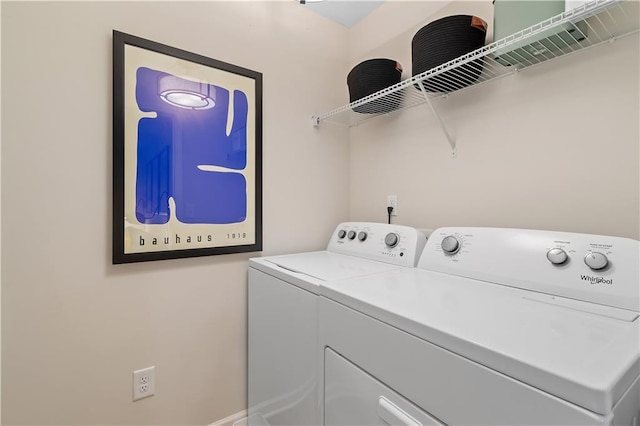 clothes washing area with laundry area and washer and clothes dryer