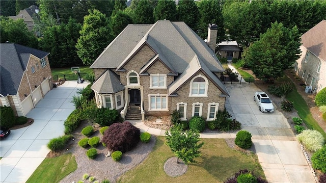 4663 Mossey Dr, Lithonia, GA 30038 - view of front of home with driveway, a chimney, and brick siding