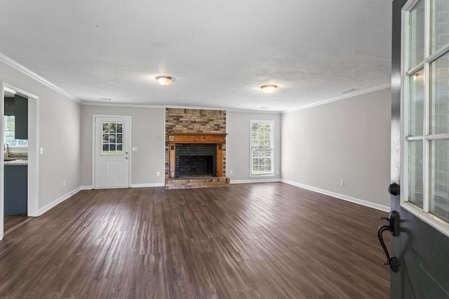 unfurnished living room with dark hardwood / wood-style flooring, plenty of natural light, and a fireplace