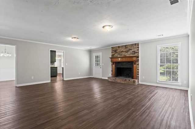 unfurnished living room featuring dark hardwood / wood-style floors, a brick fireplace, and crown molding