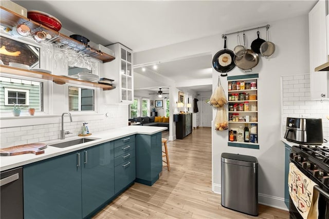 233 Spence Ave SE, Atlanta, GA 30317 - kitchen featuring a sink, gas range oven, backsplash, stainless steel dishwasher, and ceiling fan