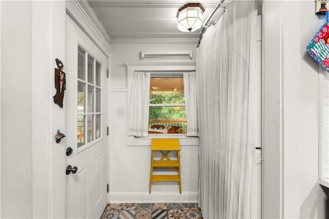 233 Spence Ave SE, Atlanta, GA 30317 - entryway featuring an AC wall unit, crown molding, baseboards, and tile patterned floors