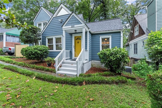 233 Spence Ave SE, Atlanta, GA 30317 - bungalow-style house with central AC unit, a front yard, and roof with shingles