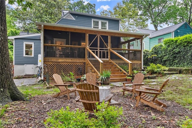233 Spence Ave SE, Atlanta, GA 30317 - back of property with a sunroom, a fire pit, and stairs