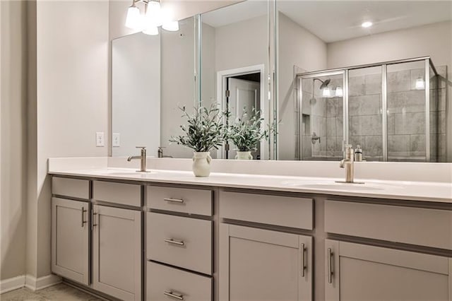 bathroom with a shower with door and vanity