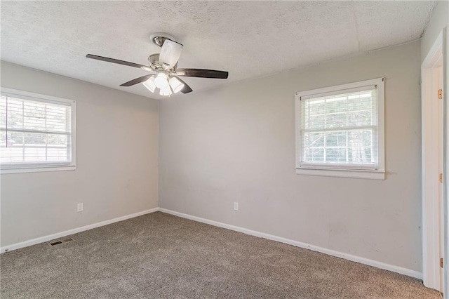 carpeted empty room featuring a textured ceiling and ceiling fan