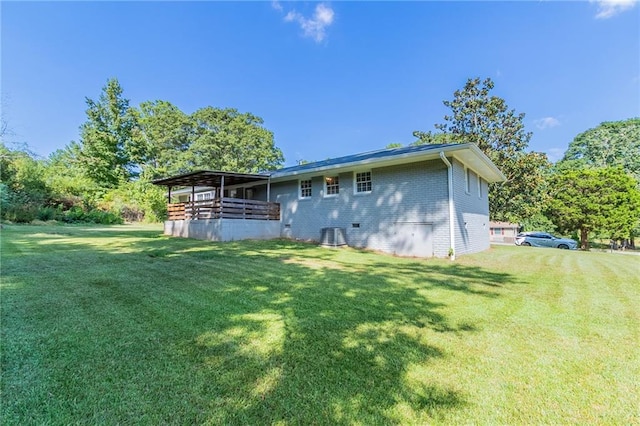 back of property featuring a lawn and central AC