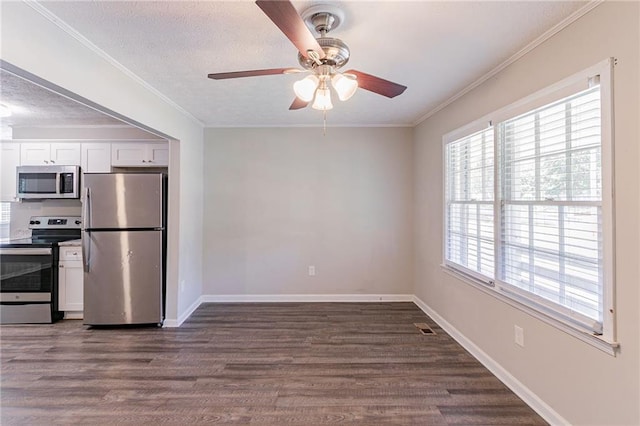 unfurnished dining area featuring ornamental molding, dark hardwood / wood-style flooring, ceiling fan, and a textured ceiling