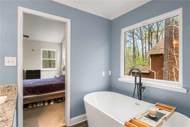 7275 Oswego Trl, Riverdale, GA 30296 - ensuite bathroom featuring a textured ceiling, ensuite bath, ornamental molding, a freestanding bath, and baseboards