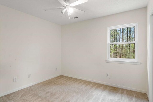 7275 Oswego Trl, Riverdale, GA 30296 - empty room with light carpet, ceiling fan, baseboards, and visible vents