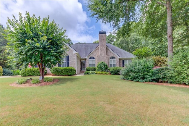 161 Southampton Cir, Hoschton, GA 30548 - ranch-style house featuring a chimney, a front yard, and brick siding